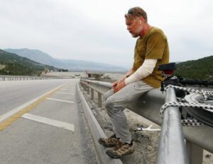 Karl Bushby sits on the side of the road in Turkey