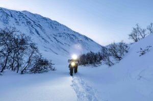 Nacho Pellejero pushes his bike along the snowy trail in the Iditarod Trail Invitational.