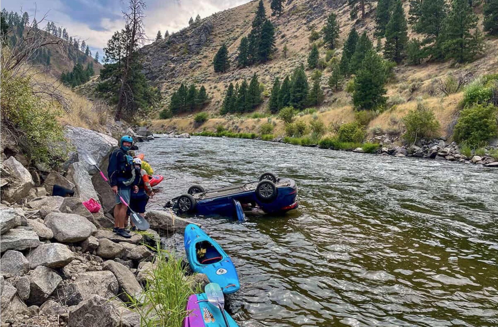 Paddlers help rescue passengers from a car in the river