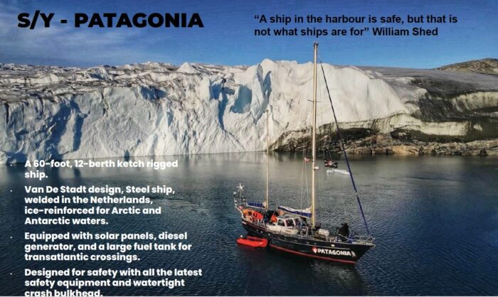 A sailboat close to a glaciated coastline