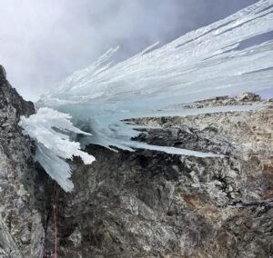 icicles hanging from a rock overhang.
