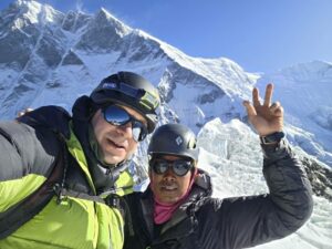 A Polish climber and a Sherpa on the summit of Island Peak, Lhotse's South face behind.