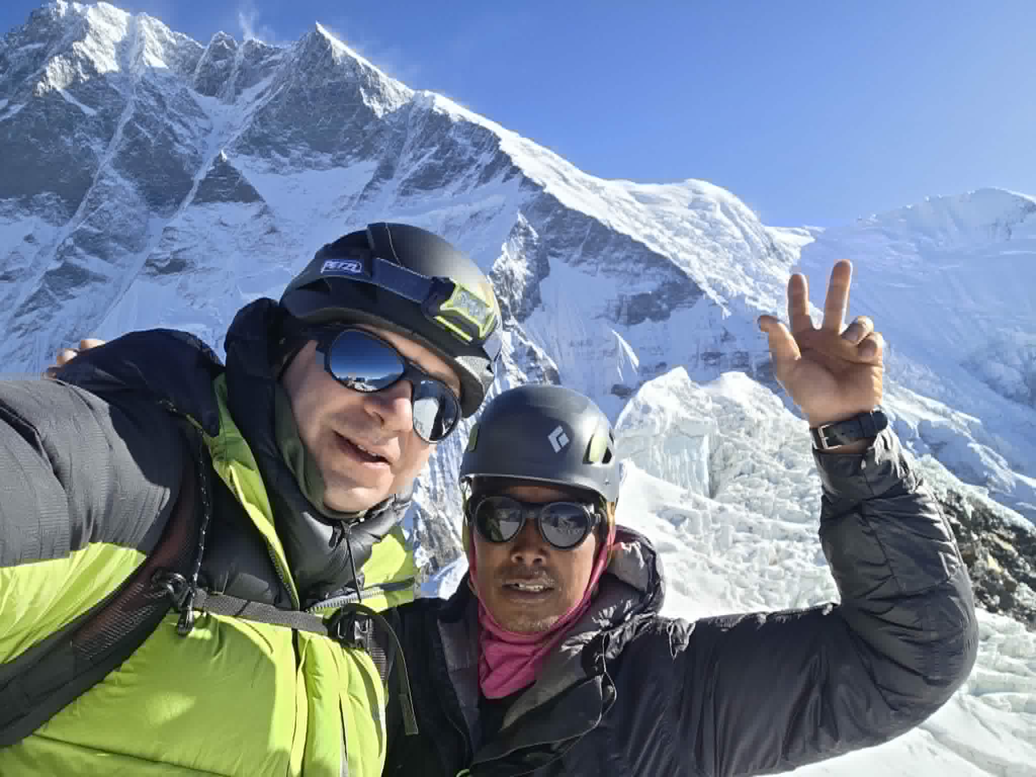 A Polish climber and a Sherpa on the summit of Island Peak, Lhotse's South face behind.