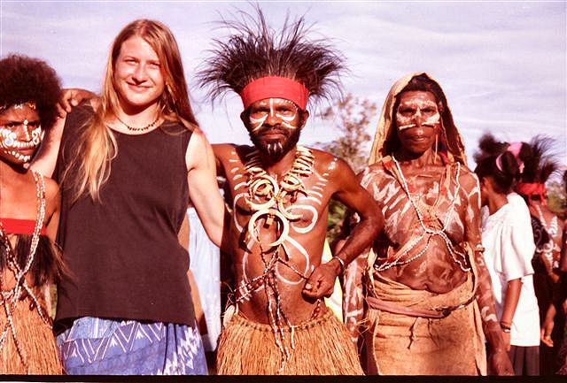 American writer Kira Salak standing with Papuan tribes people 