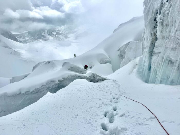 Two climbers and a rope among cvrevasses. 