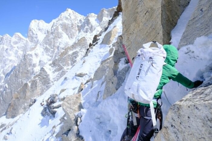 A climber traversing on mixed terrain. 