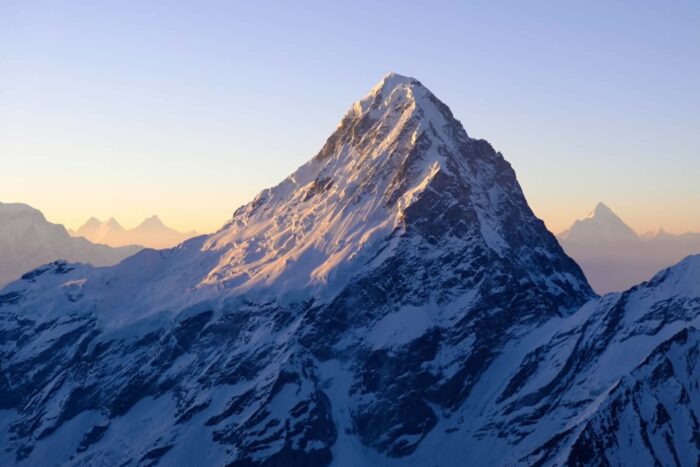 A mixed terrain and snow peak at sunrise. 
