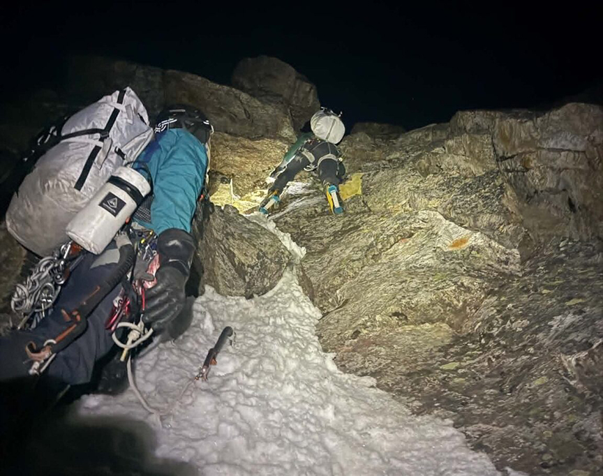 climbers in the dark by headlamp light