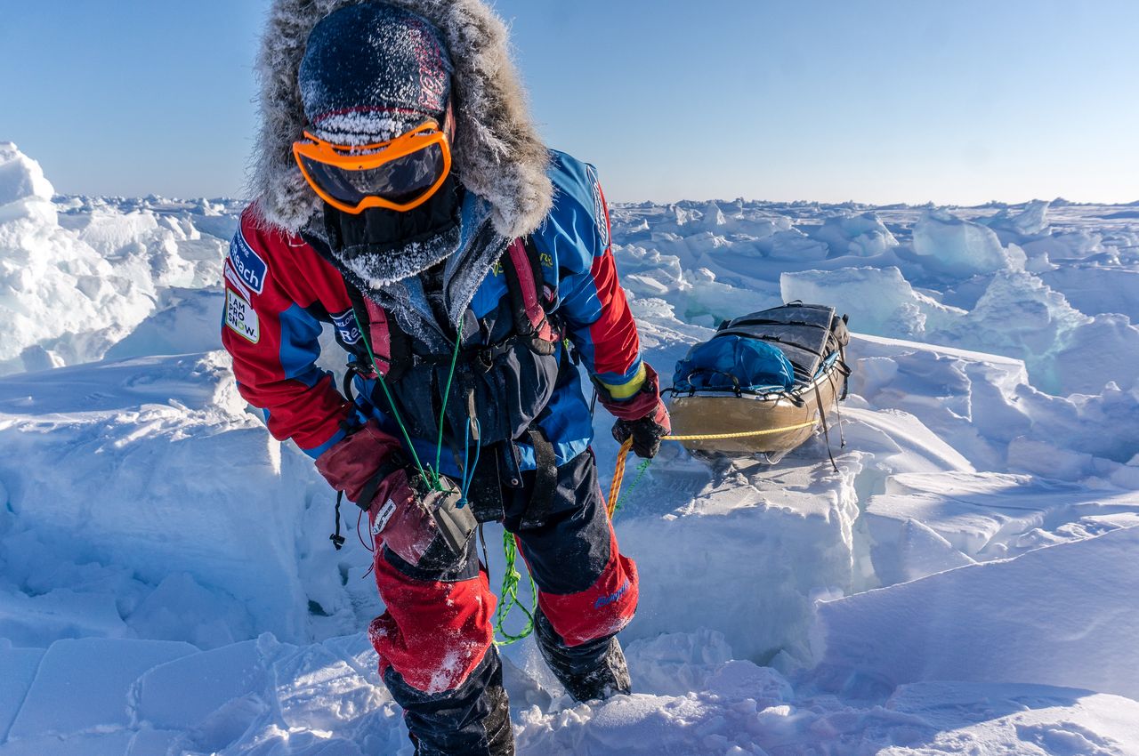 polar skier pulling sled