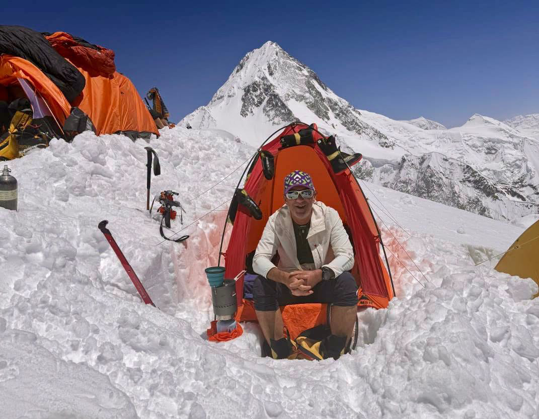 man in front of tent in snow