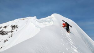 climber about to summit snowy peak