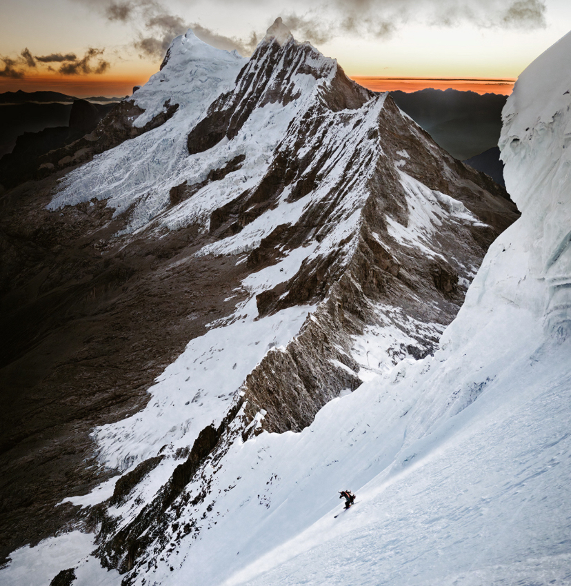 skier descending steep face