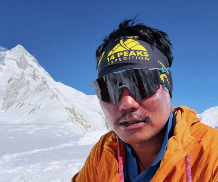 Close shot of a sherpa climber in a hot day on the snowy covered C1 of the Gasherbrums.