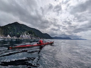 kayaker in murky seas