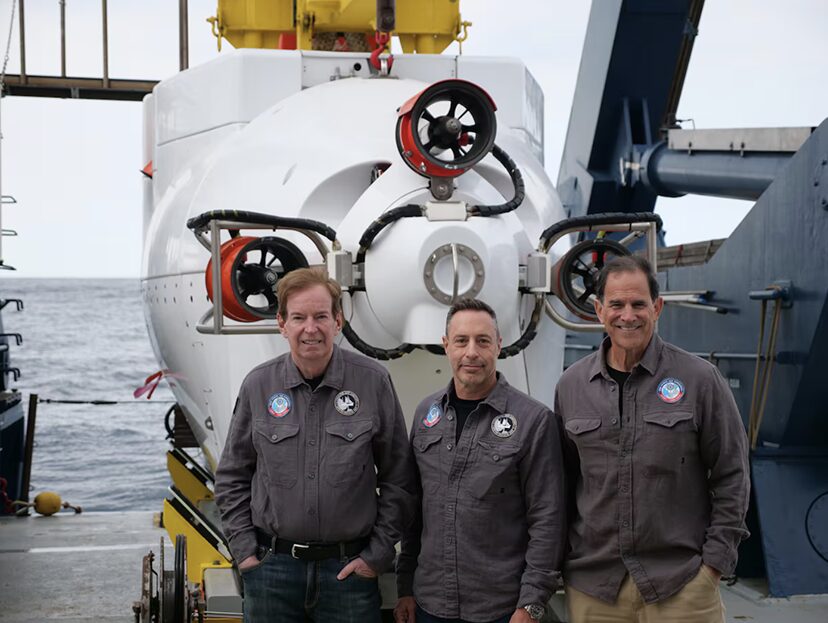 three guys in front of submersible