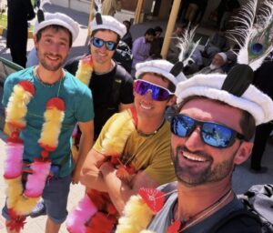 Four climbers pose smiling with Balti hats on.