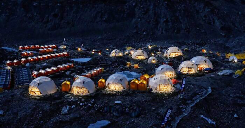 Dome tents in Everest Base Camp lit in the night.