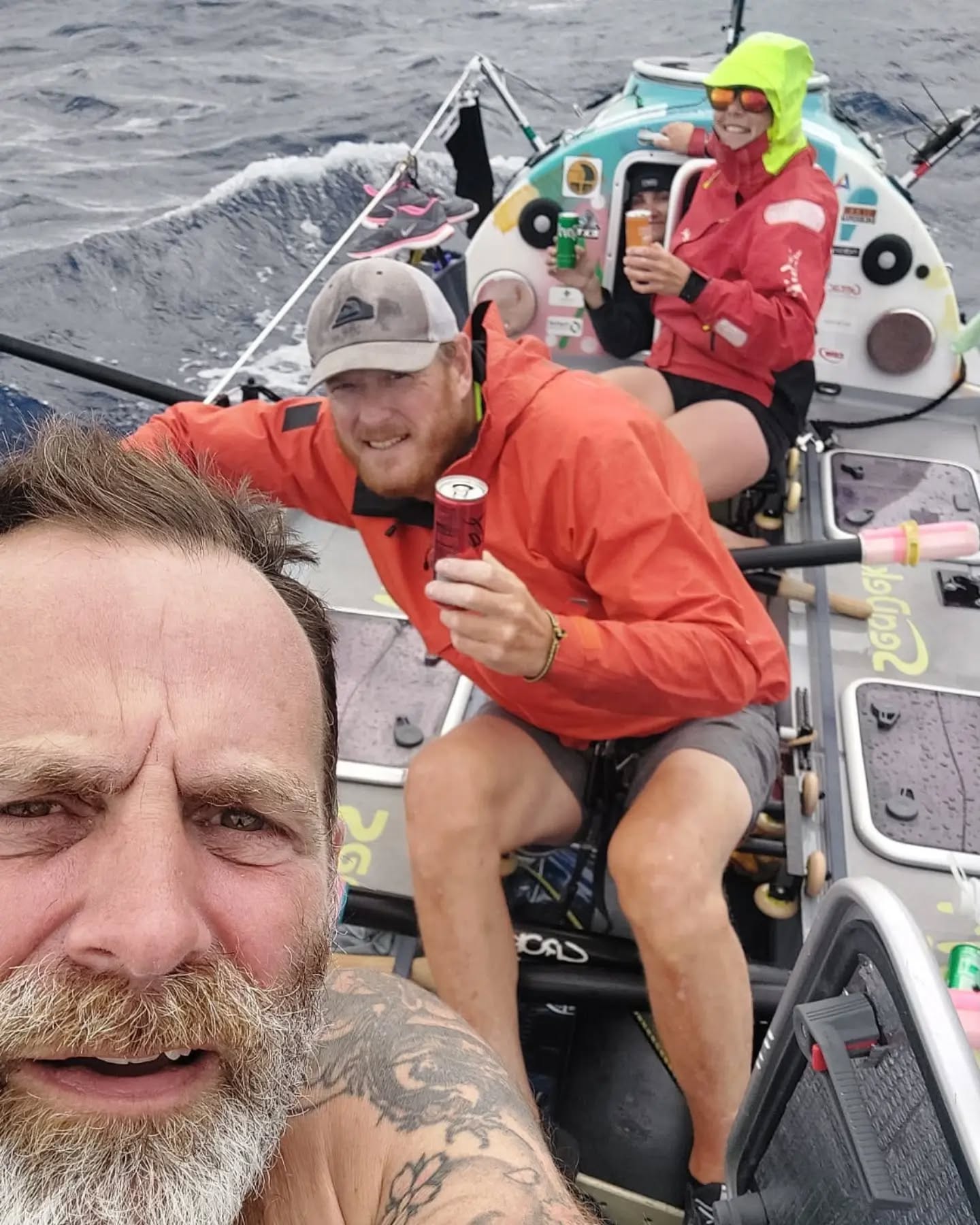 The Monkey First crew celebrate reaching 2000nm (3704km) with some cans of soft drinks