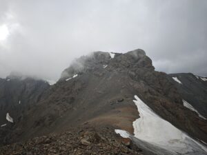 The upper sections of Muz Tau in worsening weather.