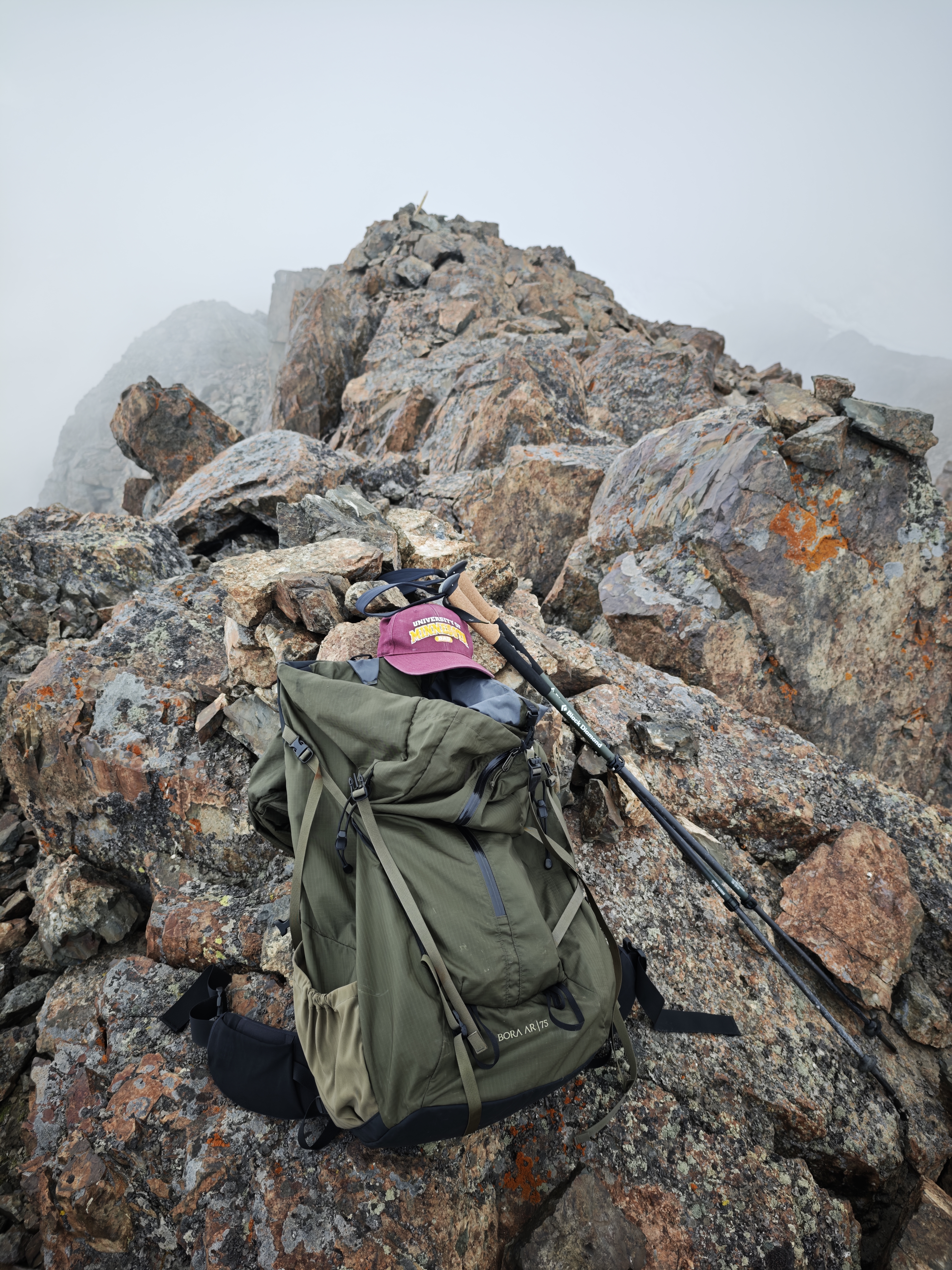 A rocky summit with some items on it.