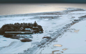 a lighthouse and observation station on a frozen shore