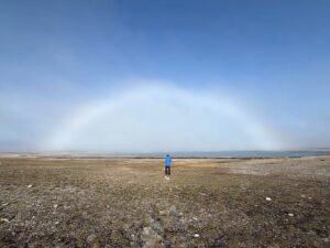 small person in middle of fogbow