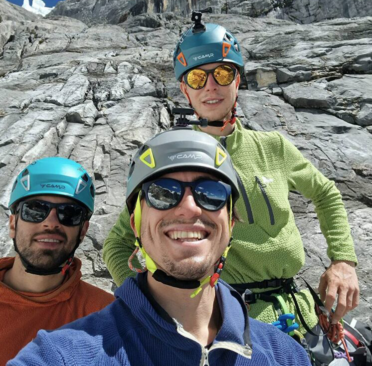 three climbers stare at the camera