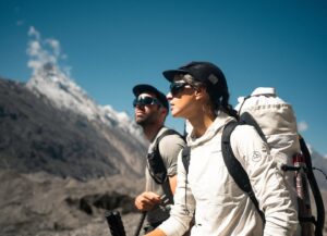 Close shot of the italian climbing couple Ragazzo and Loreggian in sunglasses and caps, at a mountain setting.