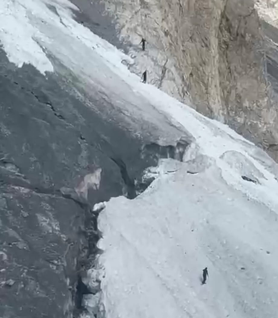 The rescuers on foot reach the accident site as seen from the air.