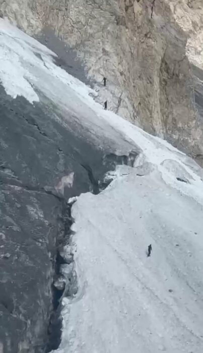 The rescuers on foot reach the accident site as seen from the air.