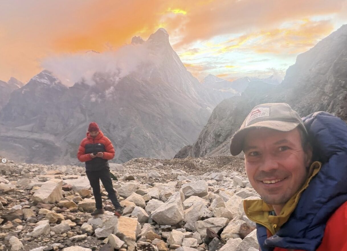 Climbers at a magical mountain setting at sunset.