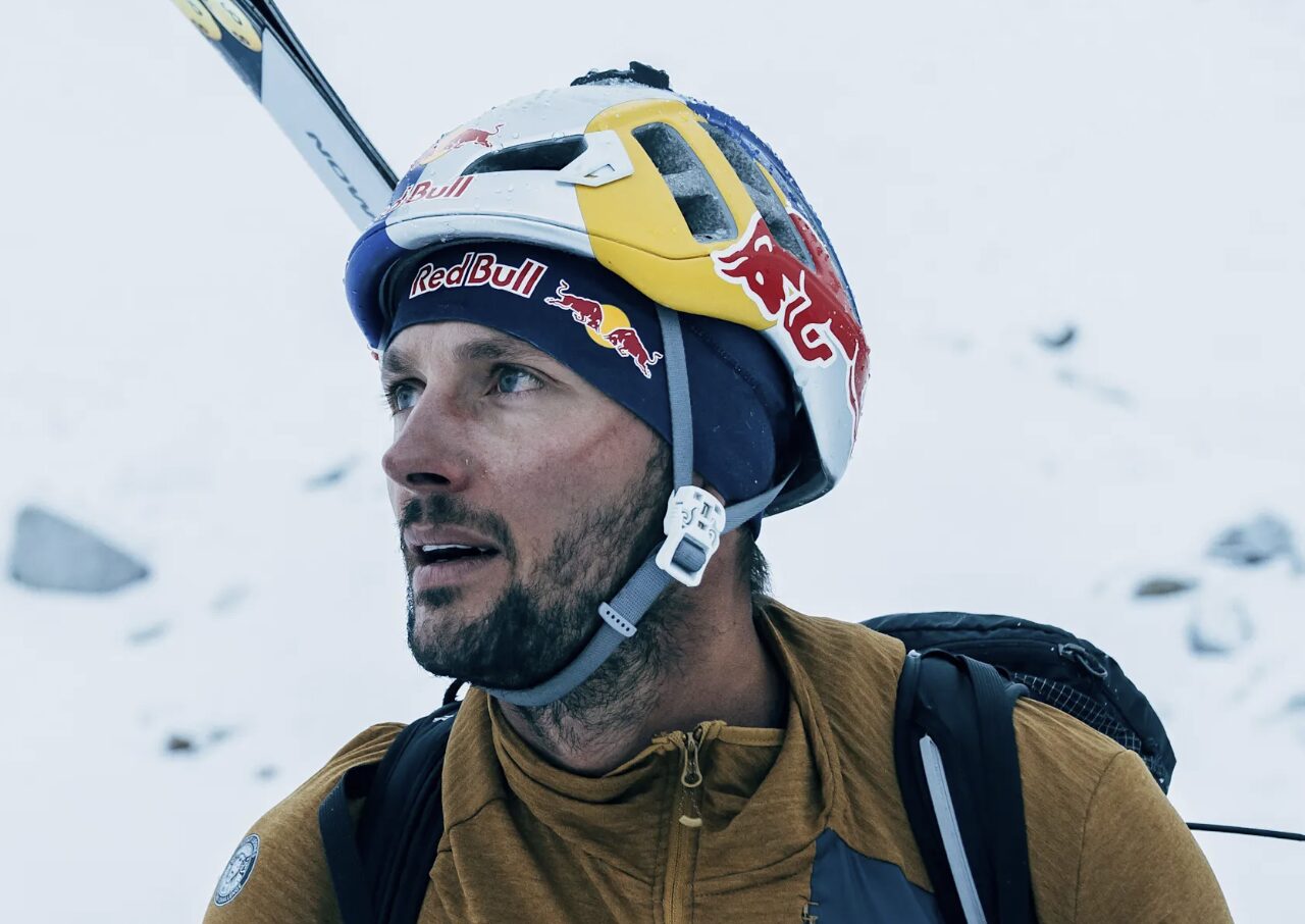 Headshot of Bargiel with helmet and skis strapped to his backpack.