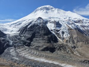 Dhaulagiri with some tents on the morraine at its base.