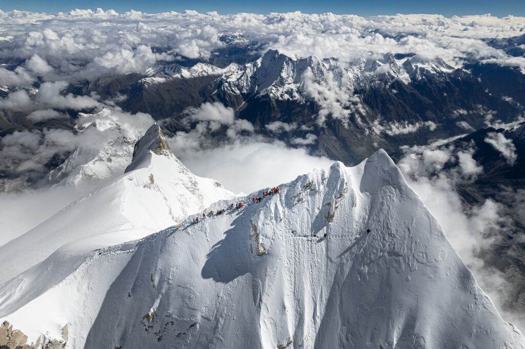 tiny climbers eeen from drone on narrowsnow ridge