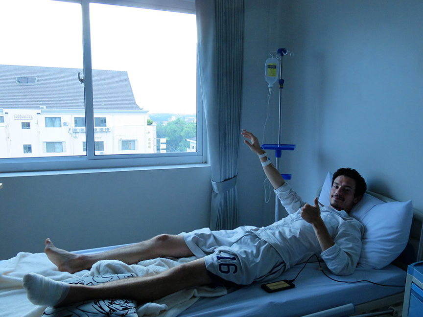 author lying in hospital bed