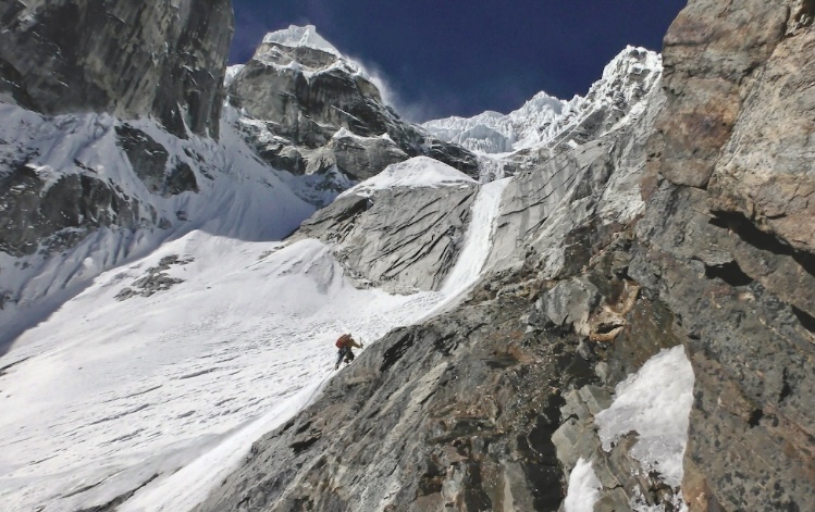 Ondrej Huserka approaching an ice smear on day three on Langtang Lirung's Easr Face in 2024.