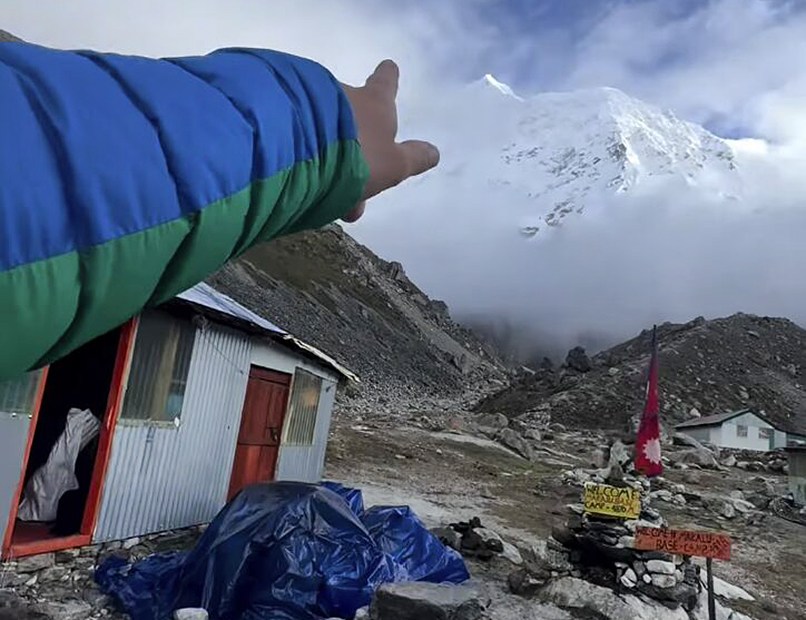A finger points to Makalu summit.