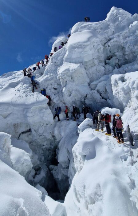 Climbers on a tight line among seracs. 