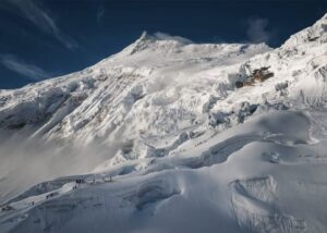 A general view of Manaslu with high camps and climbers heading up.