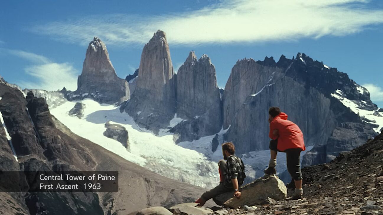Photo of two men looking at a peak, labelled "Central Tower of Paine, First Ascent 1963"