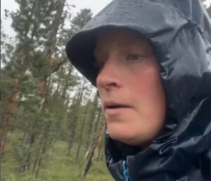 head shot of woman with rain hood