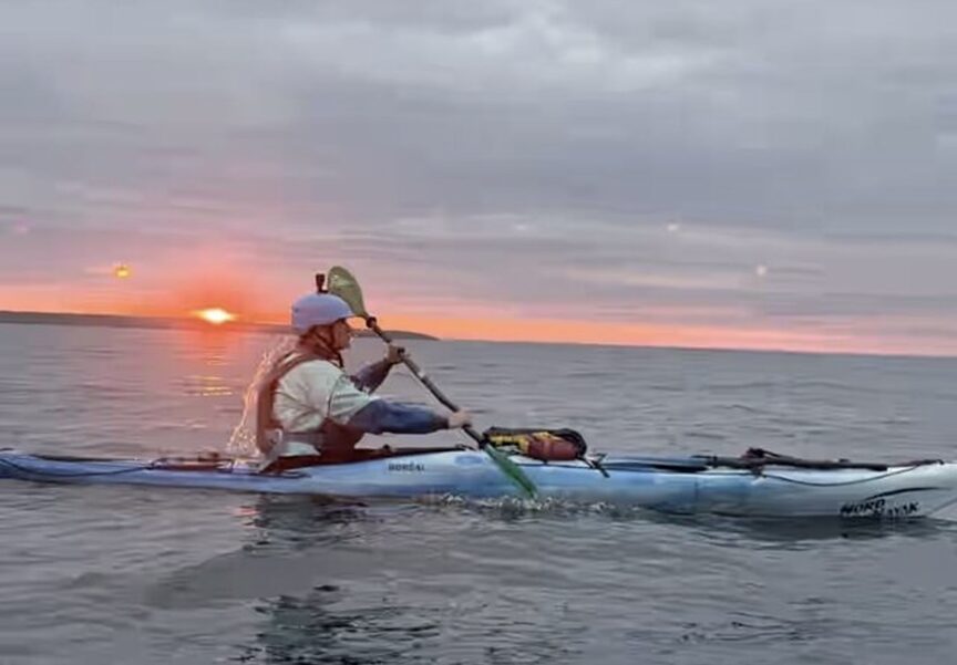 paddler at sunset