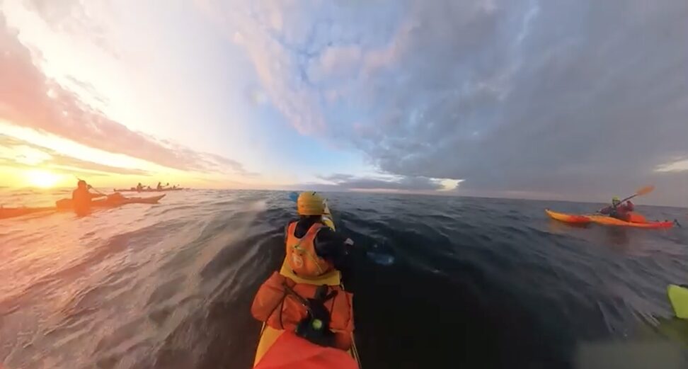 paddlers at sunset