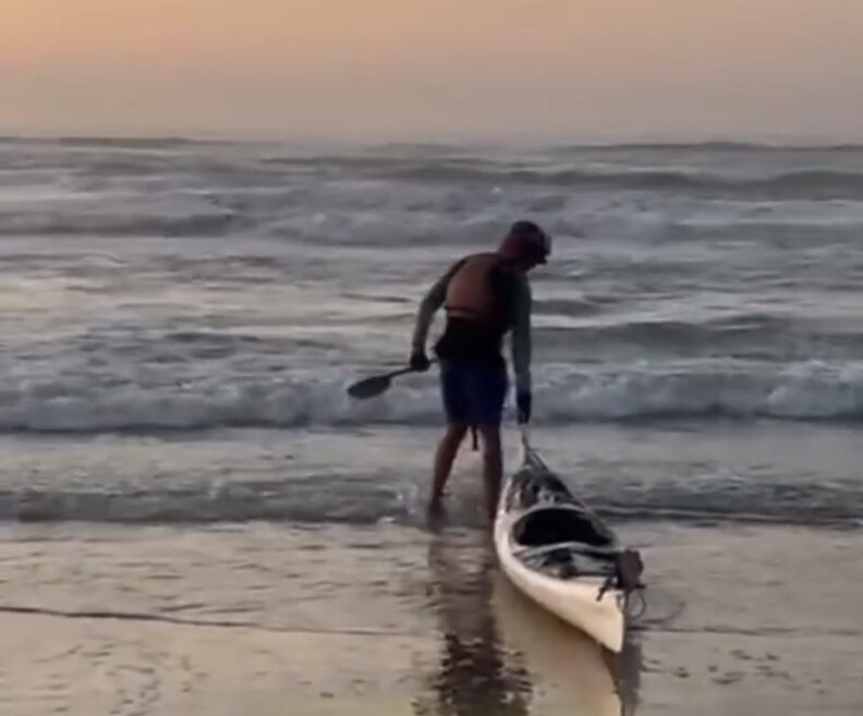 dragging kayak to edge of water