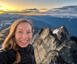 smiling woman on mountaintop