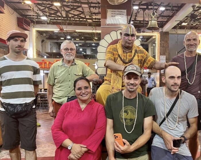 Climbers with a locak priest and an Indian womn during a blessing ceremony in a temple. 
