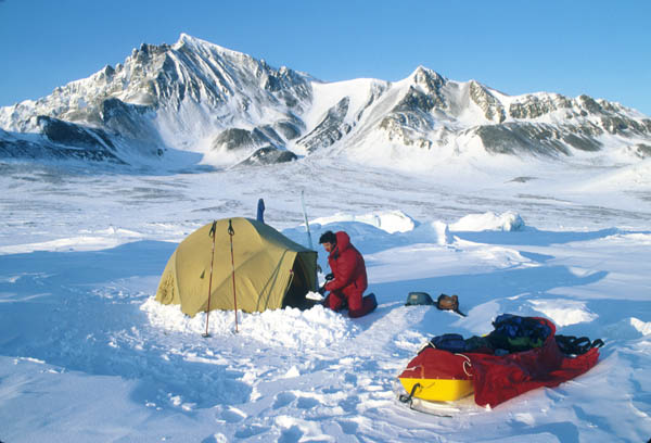 arctic camper shoveling snow