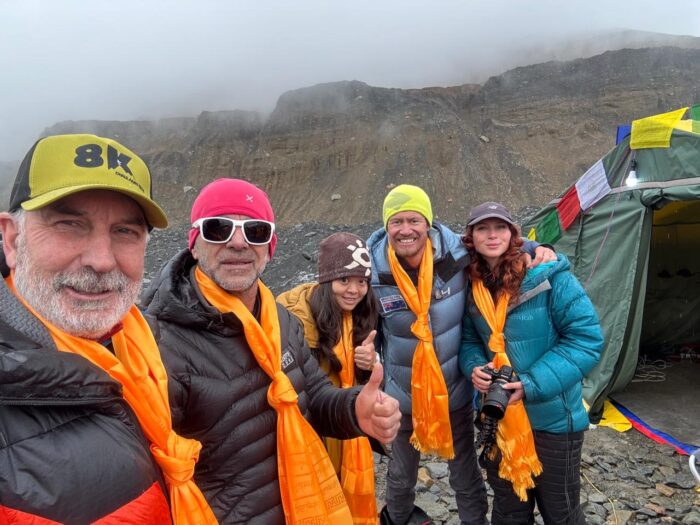 Climbers in a base camp with clouds covering the sky. 