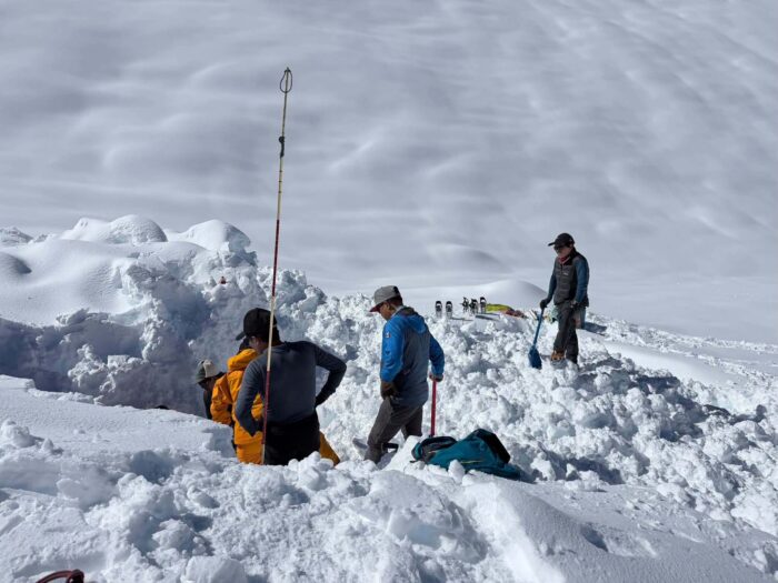 Sherpas digging in deep snow.
