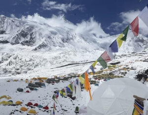 snowy camp with Nepalese prayer flags